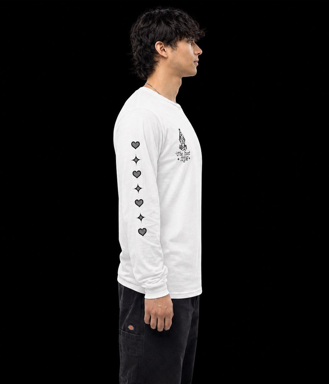 Person wearing a white long-sleeve shirt with black designs on a plain background