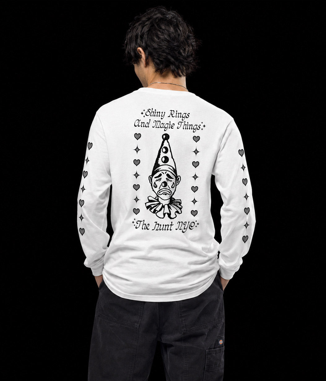 Person wearing a white long-sleeve shirt with black graphics and text on the back, against a black background.