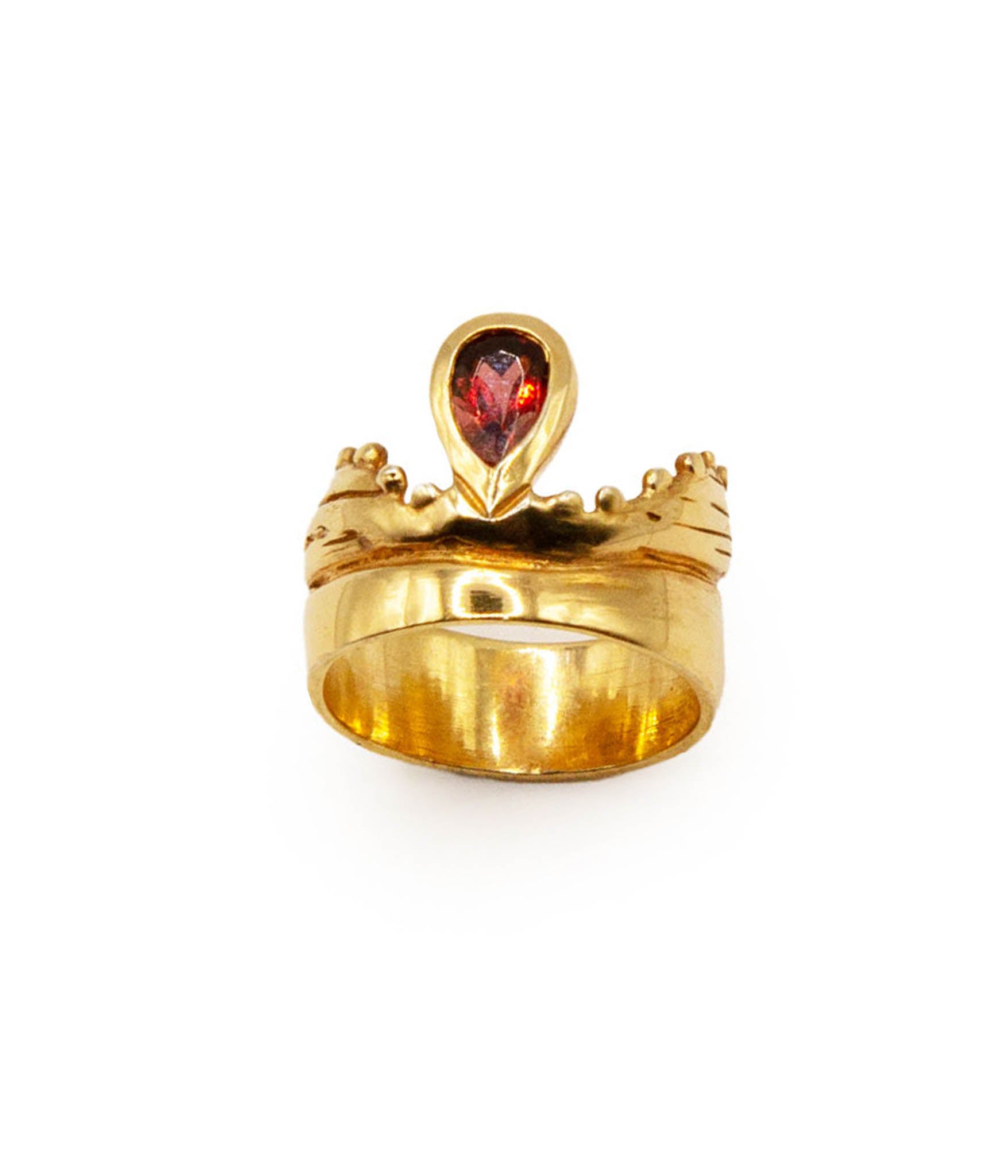 Gold ring with a red gemstone on a white background