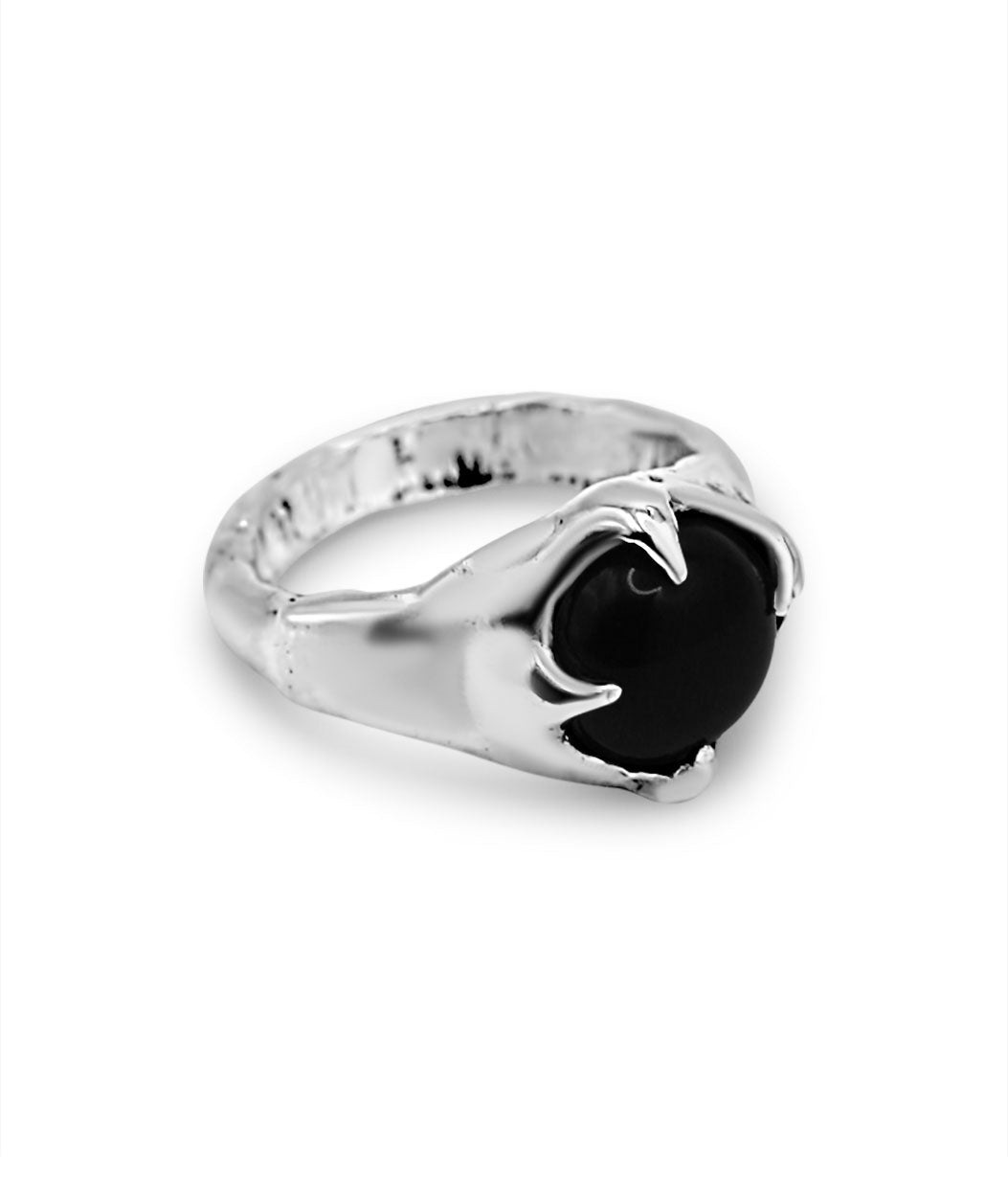 Silver ring with a black stone on a white background