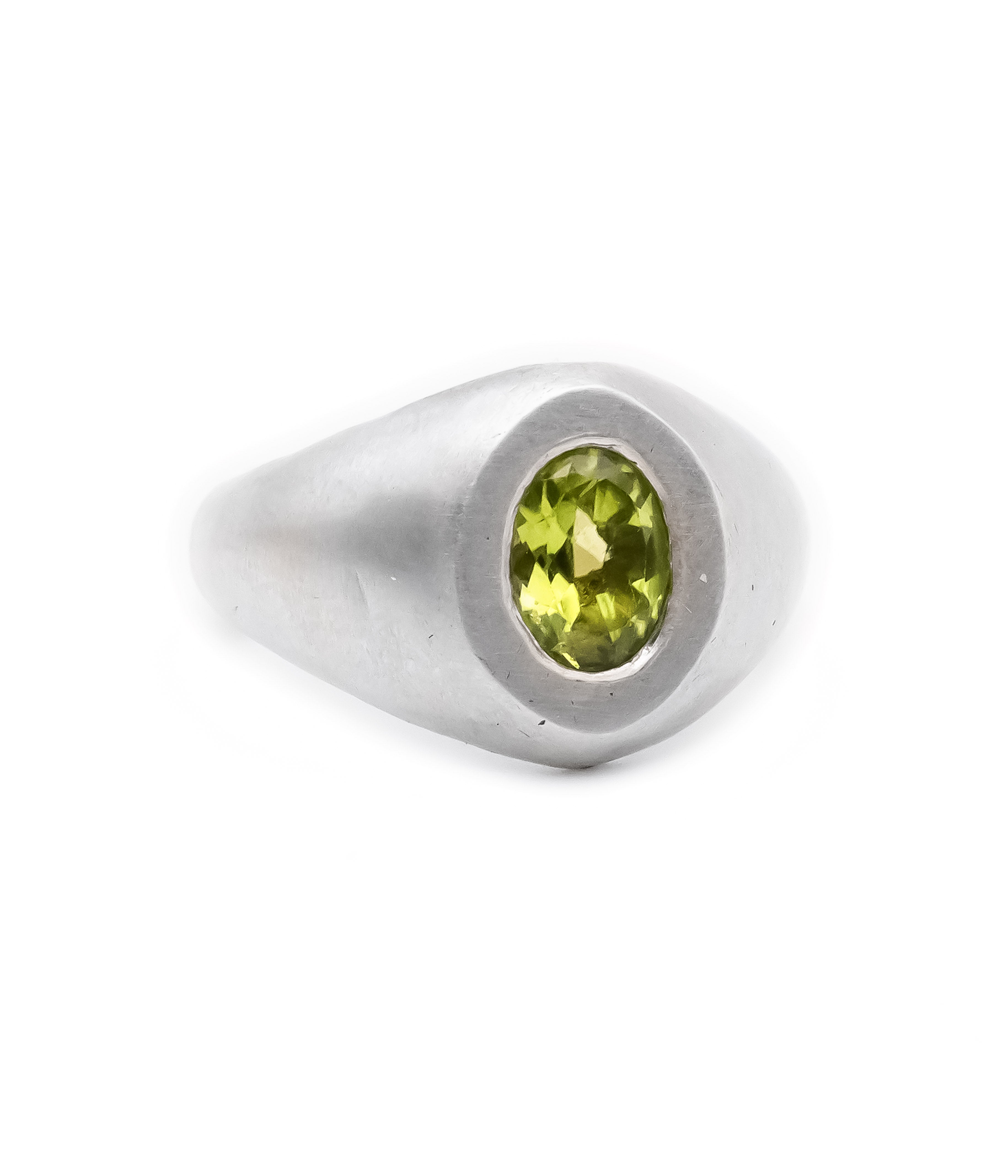 Silver ring with a green gemstone on a white background