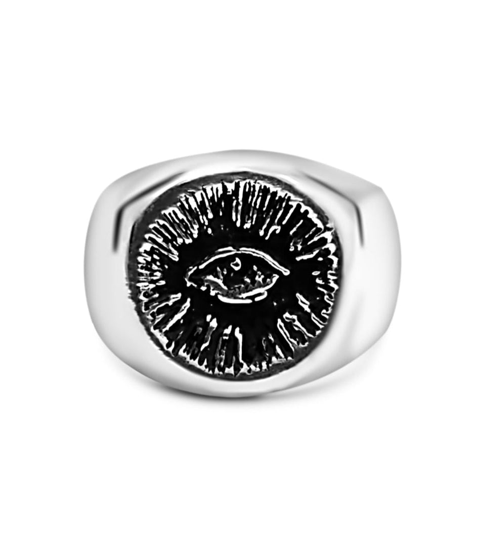 Silver ring with eye design on a white background