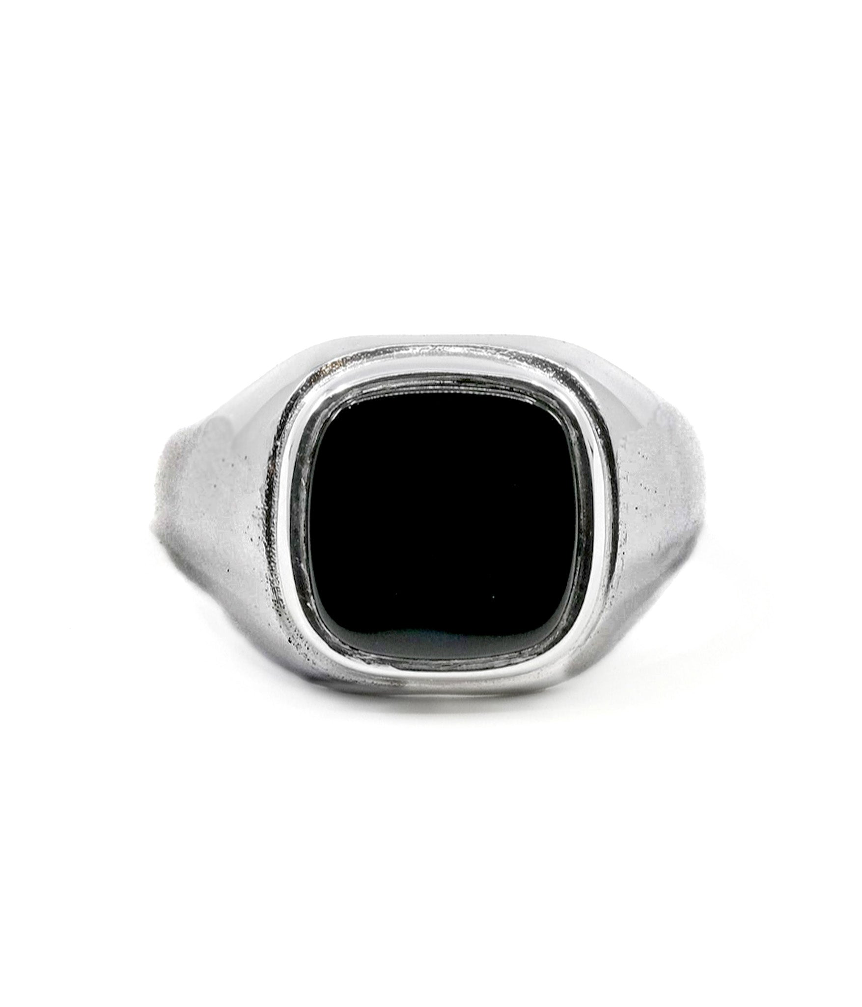 Silver ring with a black stone on a white background