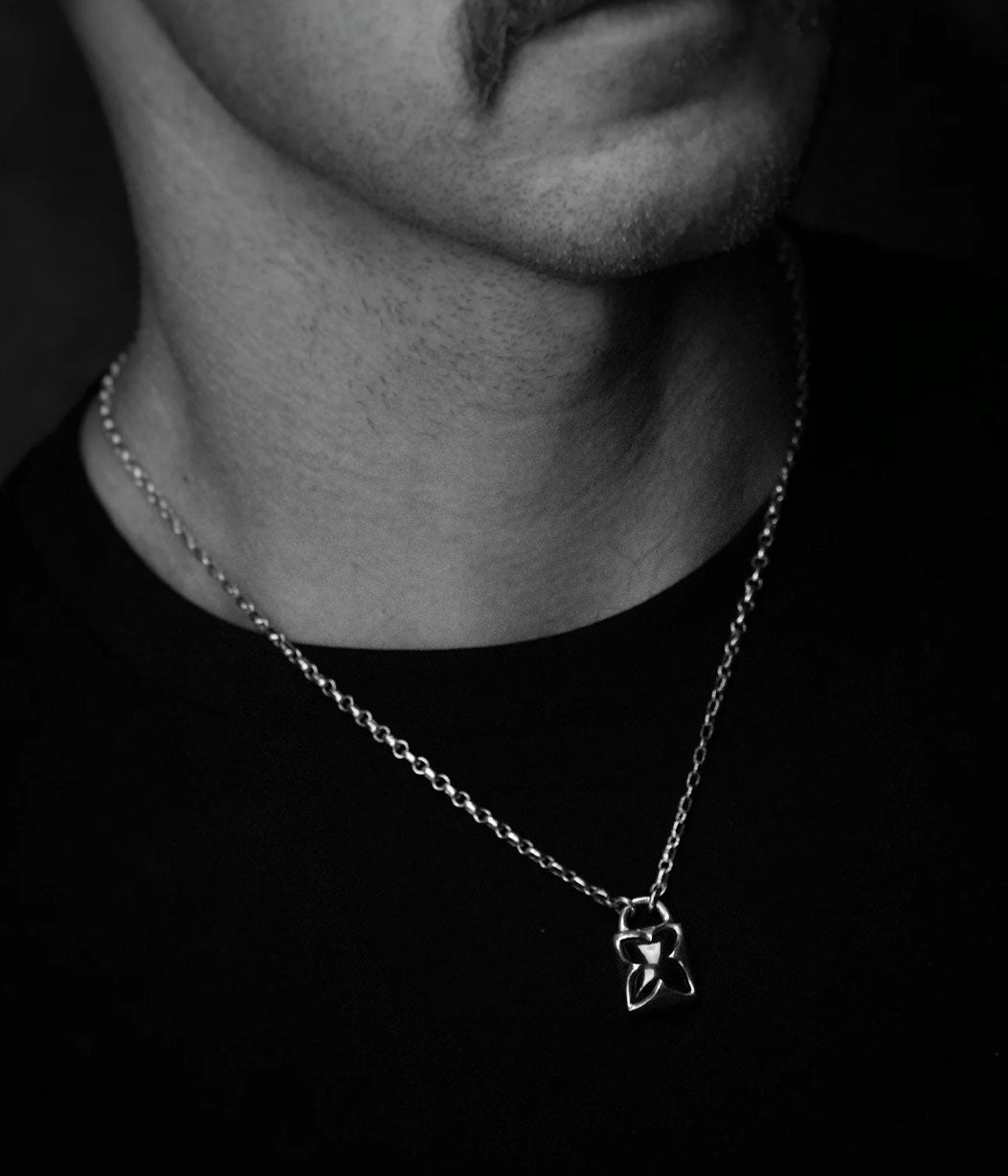 Close-up of a necklace with a pendant on a dark background