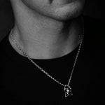 Close-up of a necklace with a pendant on a dark background