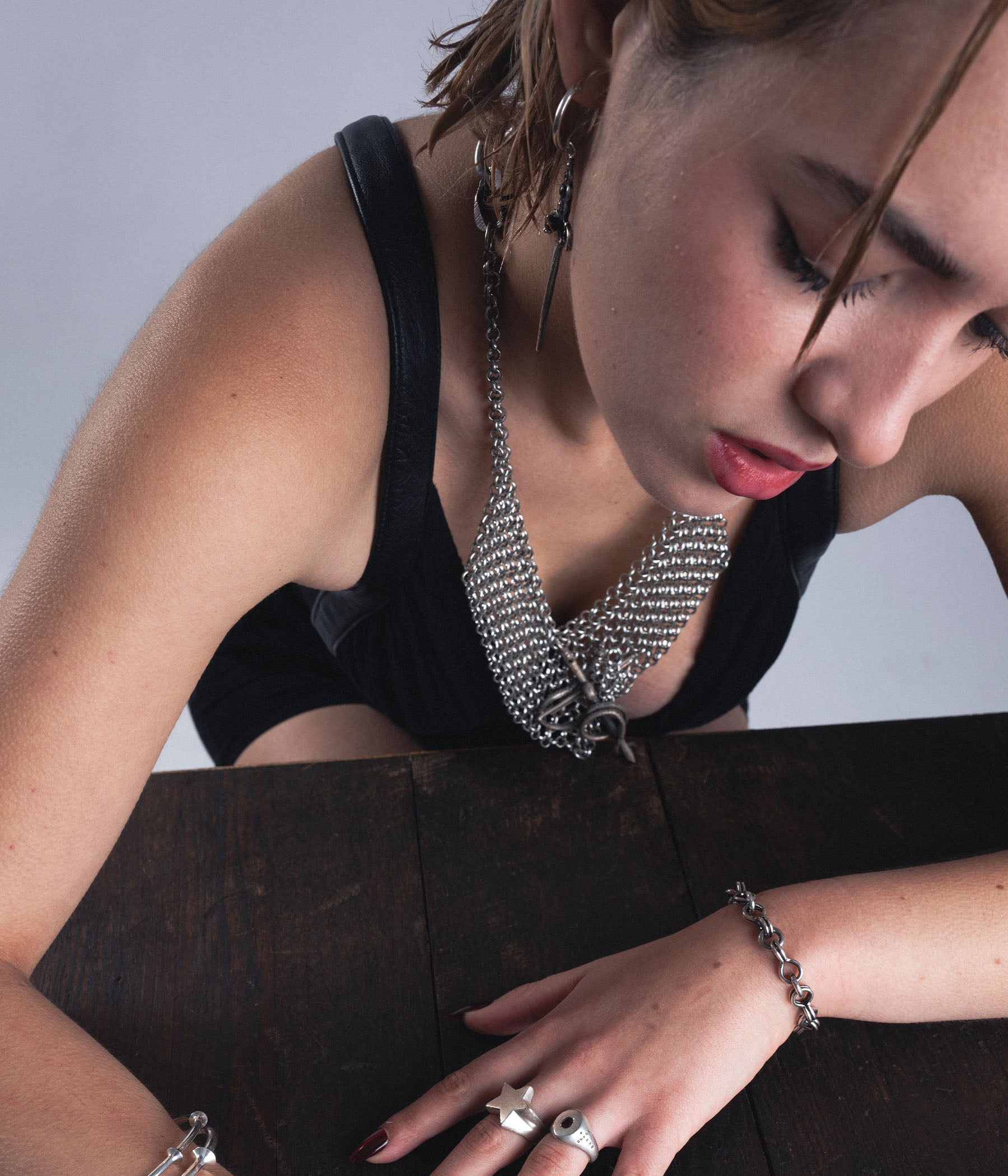 woman wearing black dress and chain necklace 