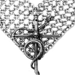 Close-up of a silver chainmaille bracelet with intricate design on a white background