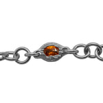 Silver chain bracelet with a central amber stone on a white background