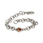 Silver chain bracelet with a heart-shaped amber stone on a white background