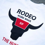 White t-shirt with black bull graphic and text 'Rodeo Work Wear Rip The Hunt' on a white background.