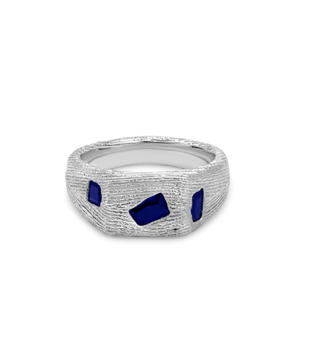 Silver ring with blue gemstones on a white background