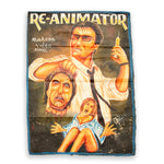 Vintage 'Re-Animator' movie poster with a horror scene on a white background