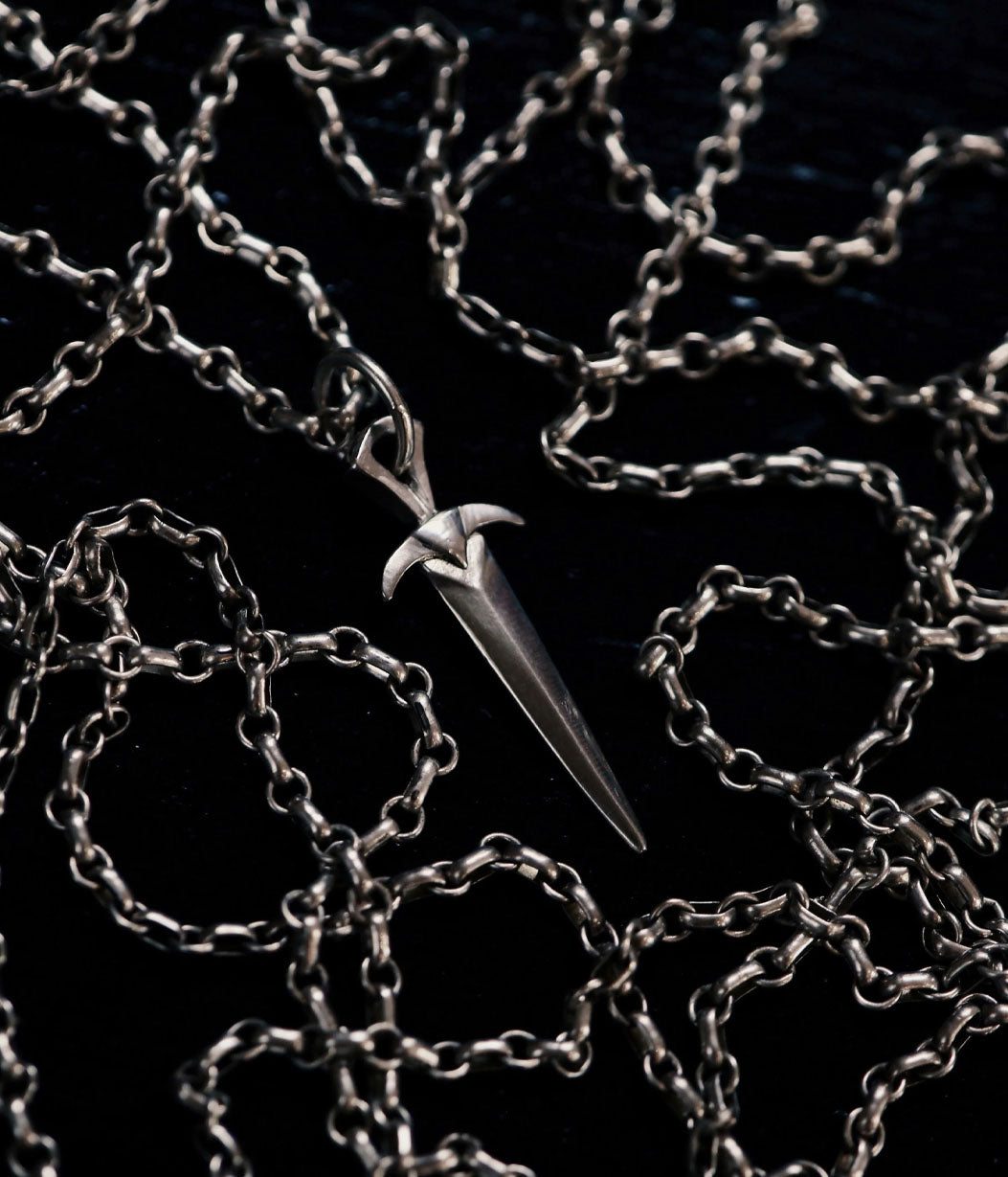 Silver chain with a unique pendant on a dark background