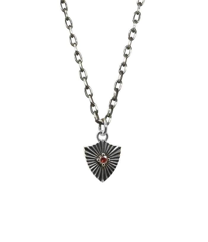 Silver necklace with a shield-shaped pendant on a white background