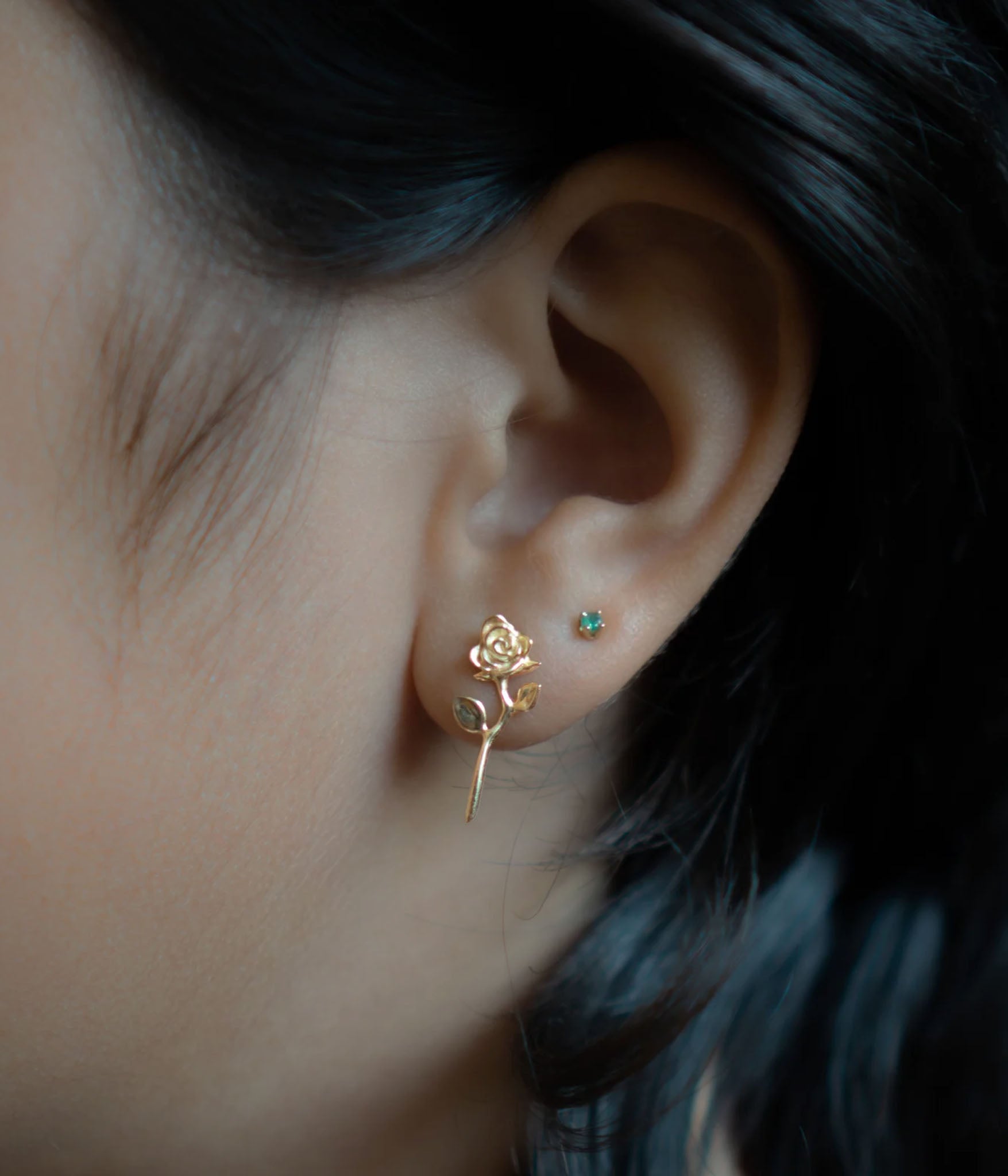 solid gold rose earring on model 