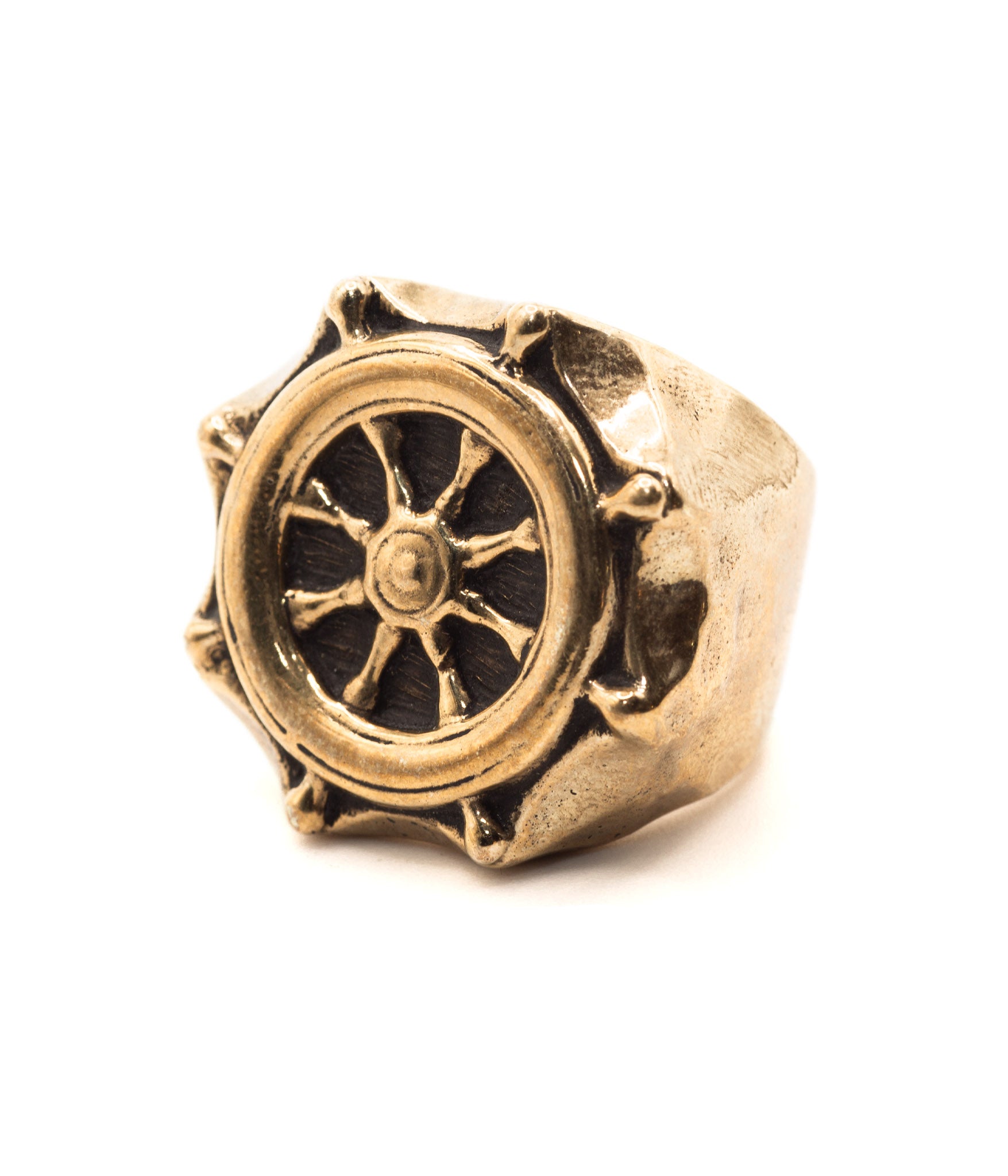 Gold ring with a wheel design on a white background