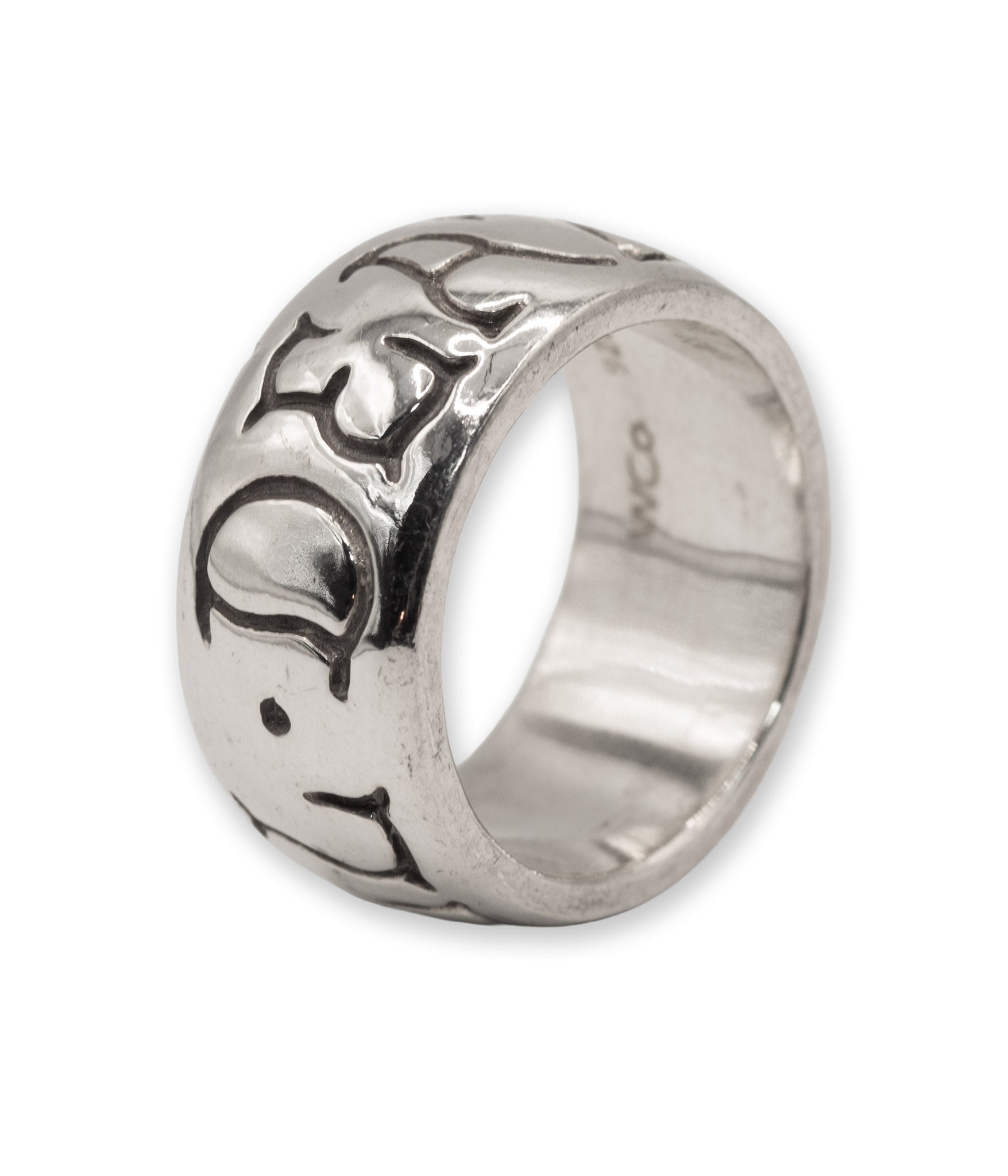 Silver ring with intricate design on a white background