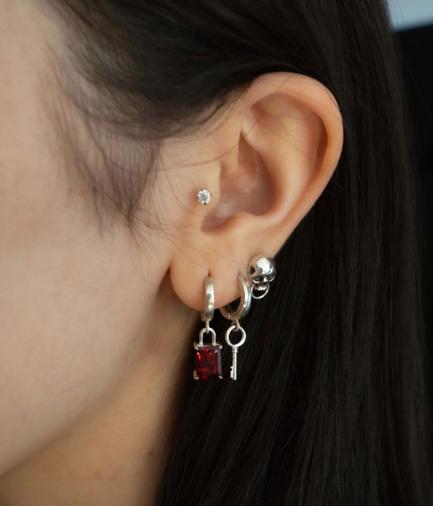 padlock and key earrings on model 