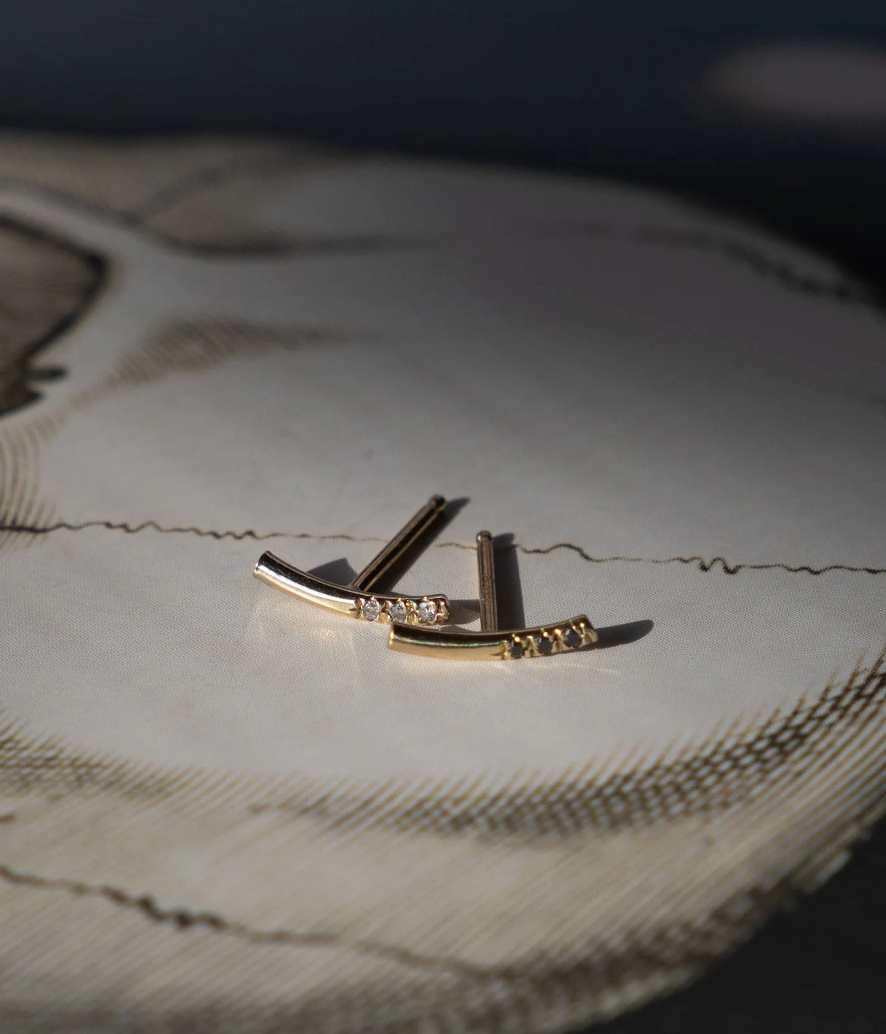 editorial shot of bar earrings on white table