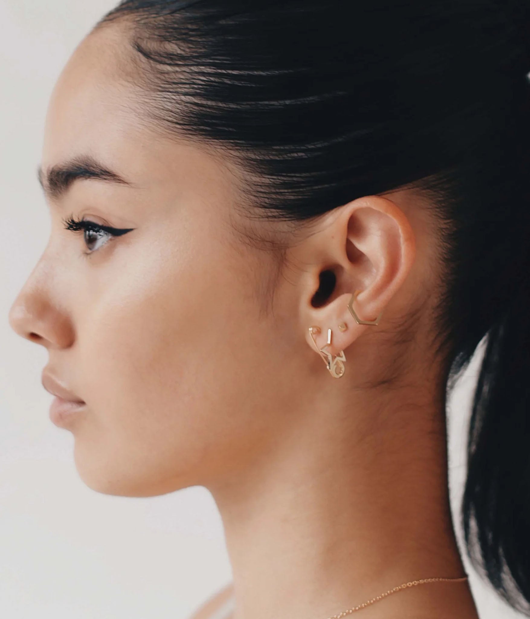 Gold Safety pin Earring on model 