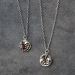two silver skull necklaces