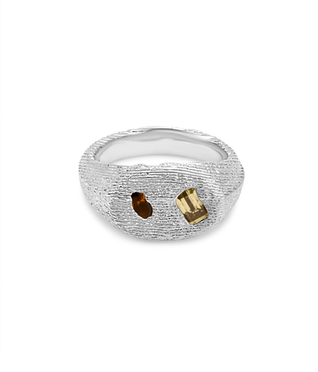 Silver ring with embedded stones on a white background