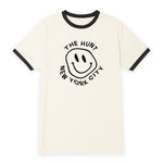 White t-shirt with black ringer design featuring a smiley face and text on a white background