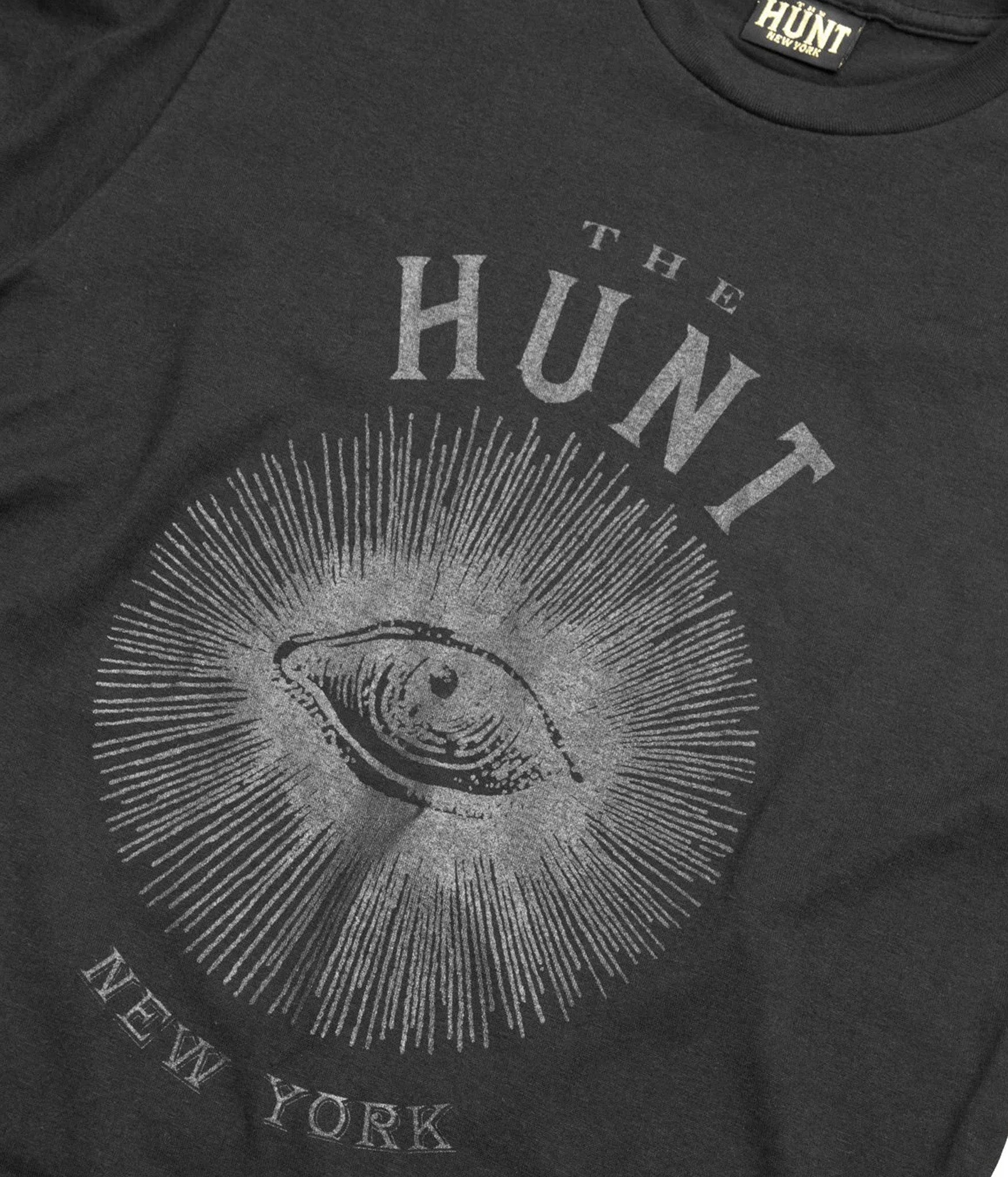 Black t-shirt with 'The Hunt New York' logo and eye design on a dark background