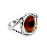 Silver ring with a large brown gemstone on a white background