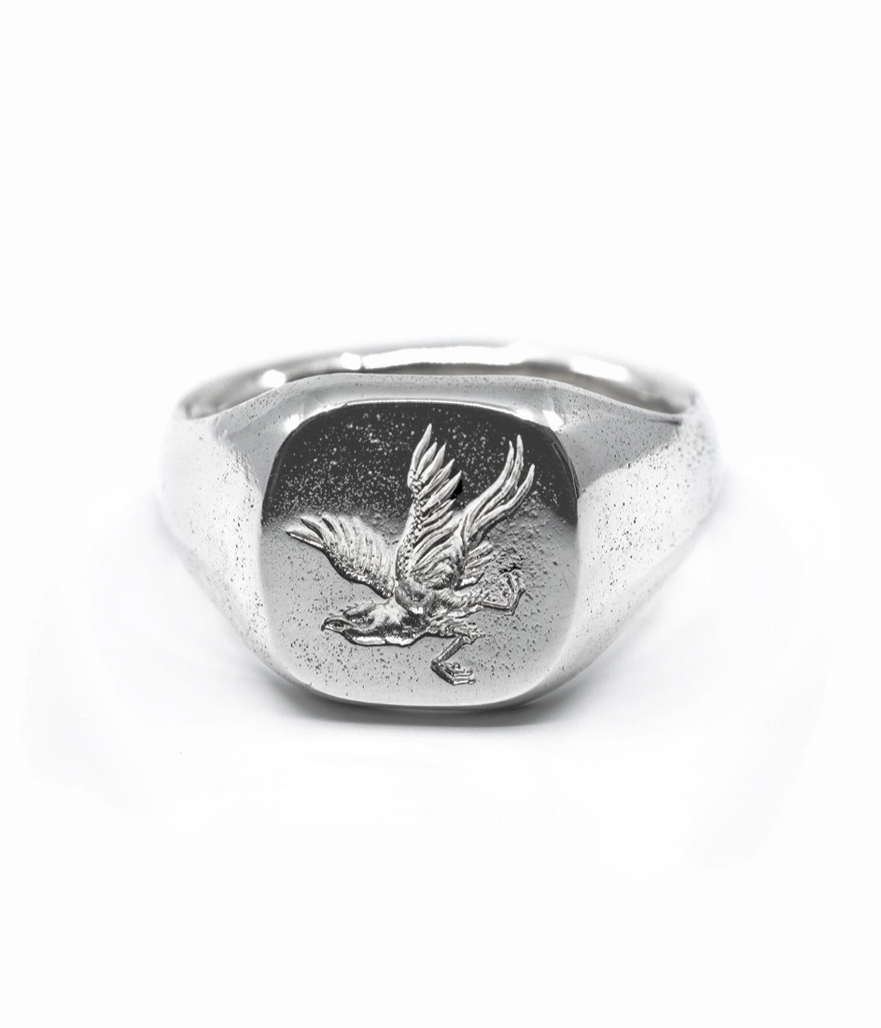 Silver ring with an eagle emblem on a white background