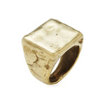 Gold ring with a textured surface on a white background
