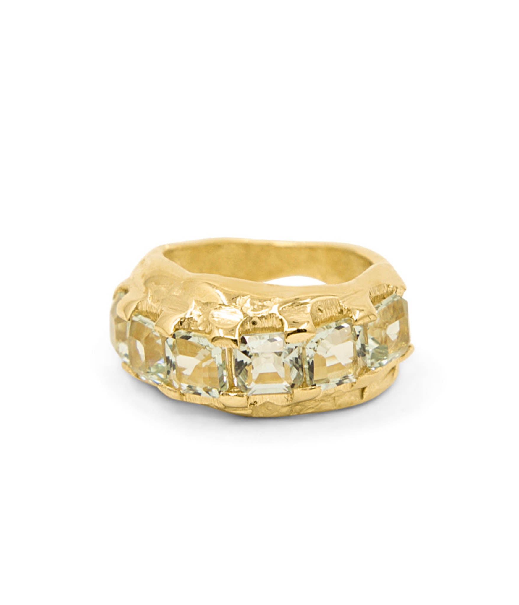 Gold ring with a textured band and clear gemstones on a white background