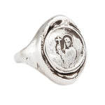 Silver ring with a religious design on a white background
