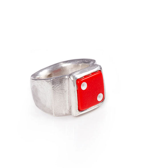 Silver ring with a red die-shaped face on a white background