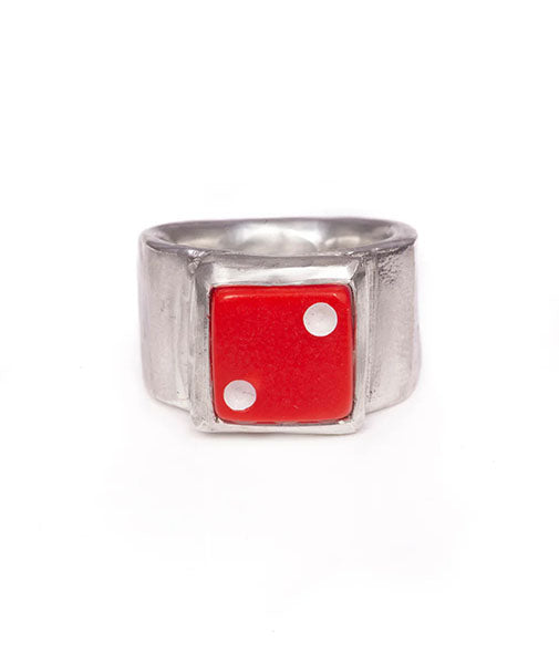 Silver ring with a red die-shaped face on a white background
