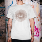 Person wearing a white t-shirt with a graphic design in front of a graffiti-covered wall.