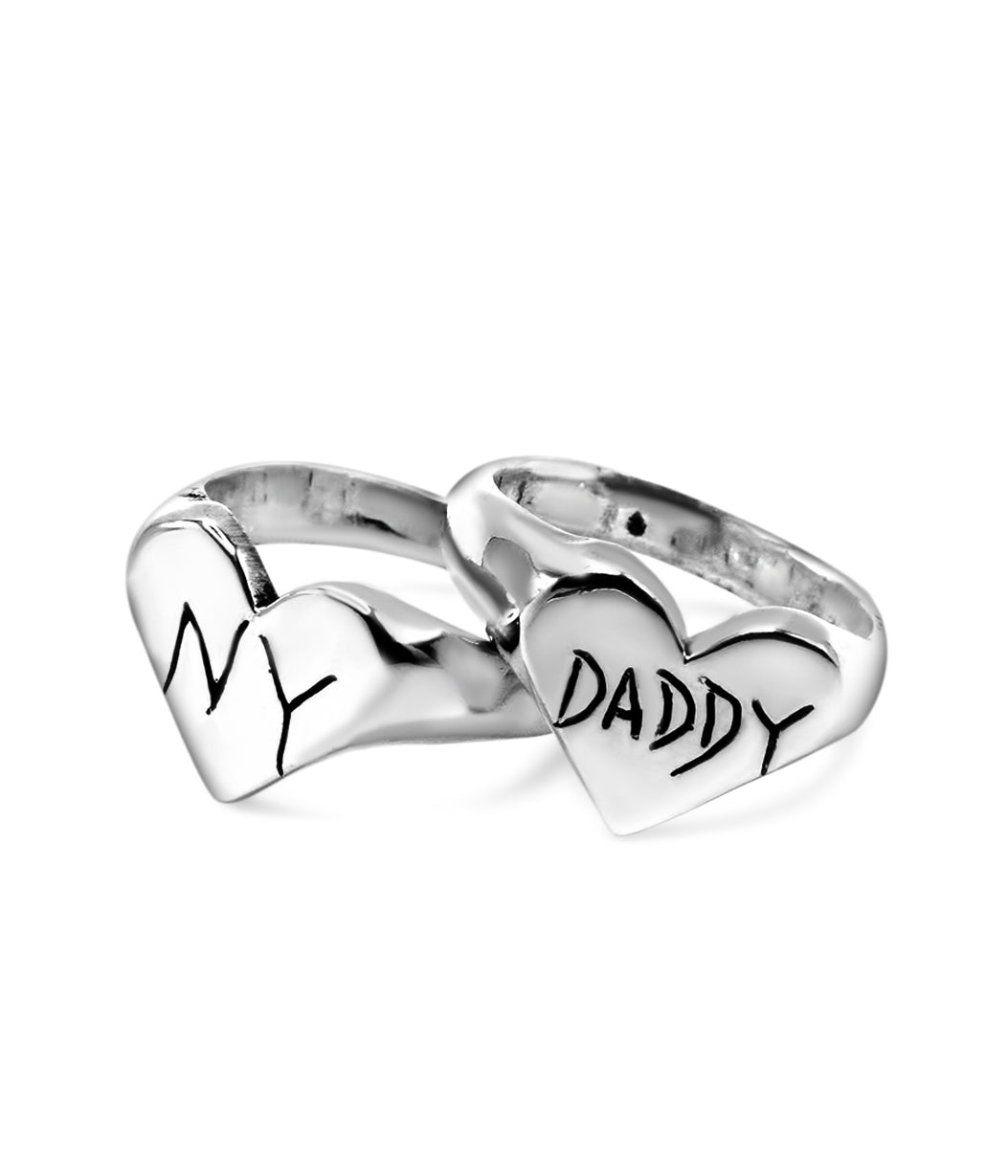 Silver heart-shaped ring with 'DADDY' and 'NY' inscriptions on a white background