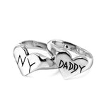 Silver heart-shaped ring with 'DADDY' and 'NY' inscriptions on a white background