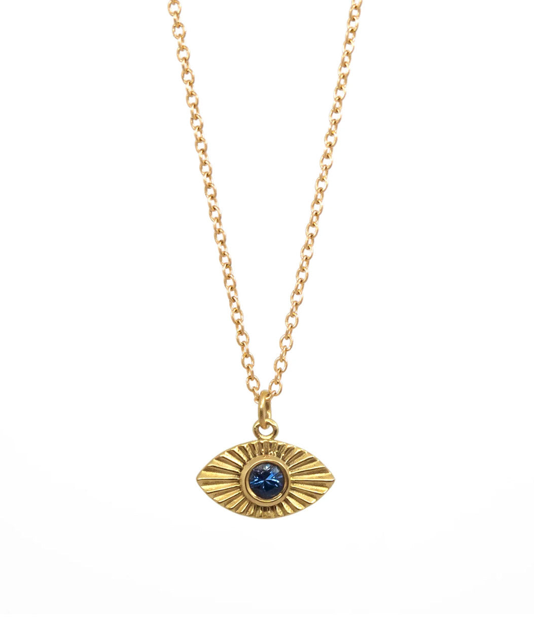 Gold necklace with an eye-shaped pendant featuring a blue gemstone on a white background