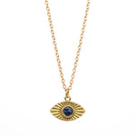 Gold necklace with an eye-shaped pendant featuring a blue gemstone on a white background