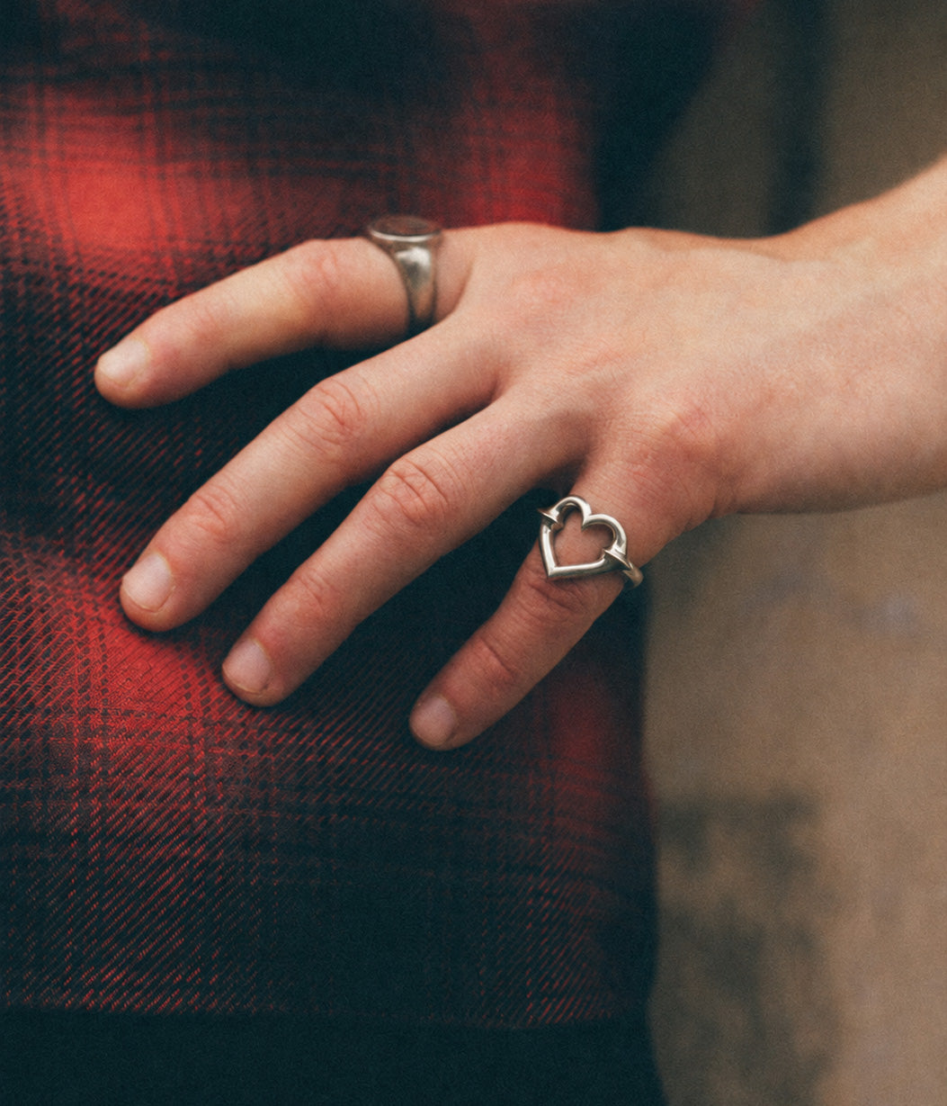 silver heart ring on pinky finger 