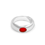 Silver ring with a red stone on a white background