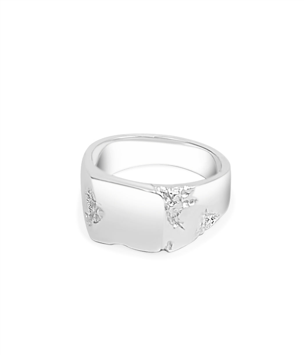 Silver ring with engraved design on a white background