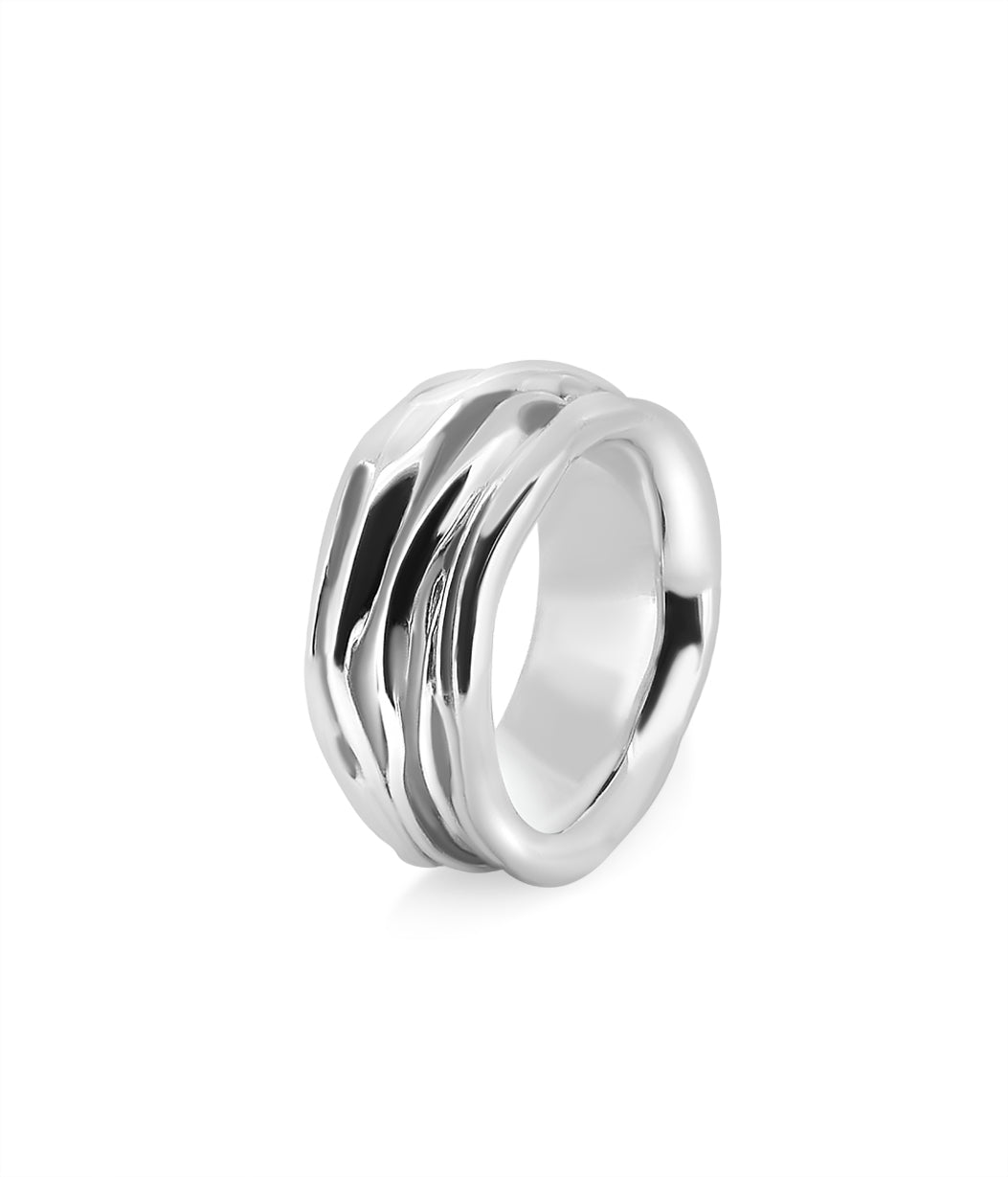 Silver ring with a wavy design on a white background