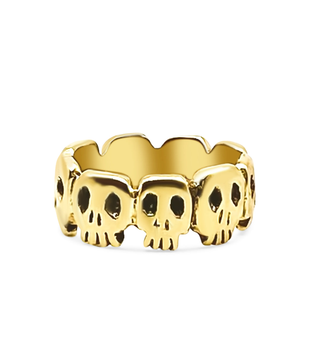 Gold skull ring on a white background