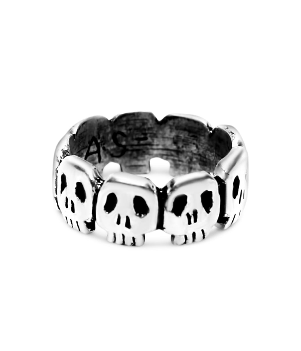Silver ring with skull designs on a white background
