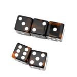 Four glossy black dice with a tortoiseshell brown pattern and white pips, arranged on a plain white background.