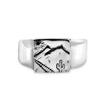 Silver ring with a black and white desert scene design on a white background