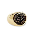 Gold ring with a black engraved design on a white background