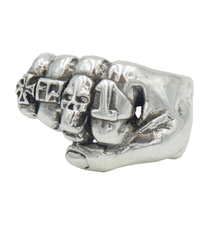 Silver ring with skull and crossbones design on a white background